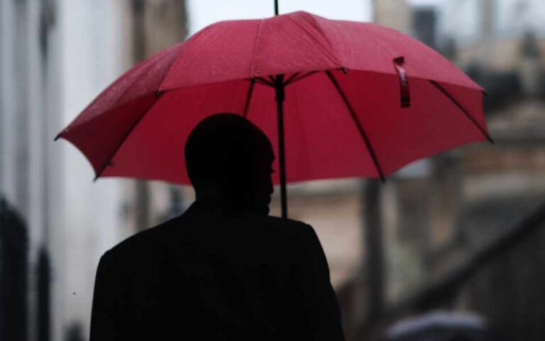 man with red umbrella